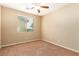 This bedroom features neutral walls, carpet, and a ceiling fan at 1172 Via Della Costrella, Henderson, NV 89011