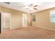 Bright bedroom featuring carpet, ceiling fan, and adjoining bathroom at 1172 Via Della Costrella, Henderson, NV 89011
