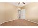 Bedroom featuring neutral walls, carpet flooring, ceiling fan and double door entrance at 1172 Via Della Costrella, Henderson, NV 89011