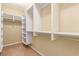 Well-organized walk-in closet features ample shelving and hanging space for wardrobe storage and access at 1172 Via Della Costrella, Henderson, NV 89011