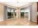 Open dining area boasts natural light from sliding doors and modern chandelier at 1172 Via Della Costrella, Henderson, NV 89011