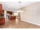 Open-concept kitchen and dining area with stainless steel appliances and tile floors at 1172 Via Della Costrella, Henderson, NV 89011
