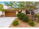 Landscaped home with stone accents, desert landscaping and a two-car garage at 1172 Via Della Costrella, Henderson, NV 89011