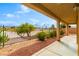 A covered patio with desert landscaping and a view visible beyond the fence at 1172 Via Della Costrella, Henderson, NV 89011