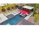Aerial view showcasing a pool, spa, lounge area, outdoor kitchen and landscaped backyard at 12119 Castilla Rain Ave, Las Vegas, NV 89138