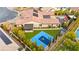 An aerial view of a luxurious property with a basketball court, pool, covered outdoor seating, and lush landscaping at 12119 Castilla Rain Ave, Las Vegas, NV 89138