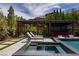 Backyard oasis with pool, hot tub, dining area, and covered lounge space at 12119 Castilla Rain Ave, Las Vegas, NV 89138
