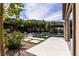 Lush backyard with patio, pool, hot tub, and landscaped garden areas at 12119 Castilla Rain Ave, Las Vegas, NV 89138