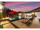 Luxurious backyard pool with tanning chairs, fire pit, and comfortable seating under a beautiful sky at 12119 Castilla Rain Ave, Las Vegas, NV 89138