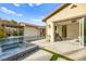 The backyard features a modern pool and spa, seamlessly connected to the home through large glass doors at 12119 Castilla Rain Ave, Las Vegas, NV 89138