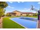Well-maintained basketball court, set against a backdrop of lush greenery and manicured landscaping at 12119 Castilla Rain Ave, Las Vegas, NV 89138
