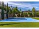 Landscaped backyard with custom-built basketball court and manicured lawn at 12119 Castilla Rain Ave, Las Vegas, NV 89138