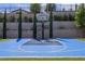 Private blue basketball court with Jordan logo, set against a landscaped backyard with retaining wall at 12119 Castilla Rain Ave, Las Vegas, NV 89138
