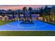 Full-sized backyard basketball court with Jordan logo, trees, lighting, and ample space for recreation at 12119 Castilla Rain Ave, Las Vegas, NV 89138
