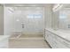 Modern bathroom with a glass shower, stone floor and double sink vanity at 12119 Castilla Rain Ave, Las Vegas, NV 89138
