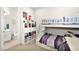 Bright bedroom with a white bunk bed, shelving, and an attached bathroom visible through the open doorway at 12119 Castilla Rain Ave, Las Vegas, NV 89138
