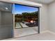 A modern bonus room boasts tile floors and access to a stunning outdoor lounge area with a pool at 12119 Castilla Rain Ave, Las Vegas, NV 89138