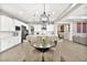 Elegant kitchen with stainless steel appliances and a breakfast nook overlooking the living area at 12119 Castilla Rain Ave, Las Vegas, NV 89138