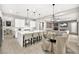 Open concept kitchen with a center island, dining area, and comfortable seating at 12119 Castilla Rain Ave, Las Vegas, NV 89138
