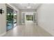 Bright living room with tile floor, slider and french doors open to the backyard with pool at 12119 Castilla Rain Ave, Las Vegas, NV 89138