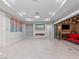Spacious living room with fireplace, backyard view, and sliding doors to outdoor living area at 12119 Castilla Rain Ave, Las Vegas, NV 89138