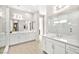 Spa-like bathroom with double vanities, quartz counters, large mirrors, and a walk-in shower with glass enclosure at 12119 Castilla Rain Ave, Las Vegas, NV 89138