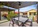 Outdoor dining area with a large table, seating for eight, and a view of the pool at 12119 Castilla Rain Ave, Las Vegas, NV 89138