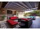 Spacious outdoor living area with a covered patio, comfortable seating, a modern grill, and a view of the sparkling pool at 12119 Castilla Rain Ave, Las Vegas, NV 89138