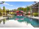 Reflective pool featuring lounge chairs, a covered pergola with red umbrellas, and landscaped surroundings at 12119 Castilla Rain Ave, Las Vegas, NV 89138