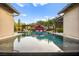 Enjoy the pristine infinity pool with stylish lounge and patio, nestled between the home's modern wings at 12119 Castilla Rain Ave, Las Vegas, NV 89138