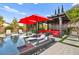 Impressive pool area with built in seating, umbrellas, and luxurious lounge furniture at 12119 Castilla Rain Ave, Las Vegas, NV 89138