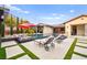Beautiful pool and patio with landscaping, lounge chairs, and seamless indoor-outdoor living at 12119 Castilla Rain Ave, Las Vegas, NV 89138