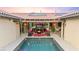 Backyard features a pool, outdoor kitchen, seating area with fire pit, and covered patio at 12119 Castilla Rain Ave, Las Vegas, NV 89138