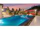 A tranquil pool view showcasing an elegant outdoor living space with a fire feature at 12119 Castilla Rain Ave, Las Vegas, NV 89138