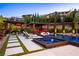 Backyard oasis featuring a luxurious pool, spa, outdoor dining, and comfortable seating areas at 12119 Castilla Rain Ave, Las Vegas, NV 89138