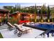 Inviting outdoor space with a pool, fire pit, and lounge seating under a pergola at 12119 Castilla Rain Ave, Las Vegas, NV 89138
