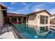 Lovely backyard pool with a modern stone design and elegant covered patio seating at 12119 Castilla Rain Ave, Las Vegas, NV 89138