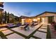 Luxury pool area with lounge chairs, fire pit, and seamless transition to the home's interior at 12119 Castilla Rain Ave, Las Vegas, NV 89138