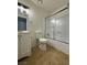 The bathroom featuring a single vanity, toilet, tile flooring, and a glass shower/tub at 1474 Santa Anita Dr # B, Las Vegas, NV 89119