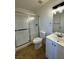 Bathroom featuring a white single vanity, toilet, and a tub shower with glass doors at 1474 Santa Anita Dr # B, Las Vegas, NV 89119