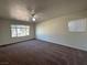 A bright bedroom featuring carpet, a ceiling fan, and large windows that let in plenty of natural light at 1474 Santa Anita Dr # B, Las Vegas, NV 89119