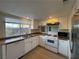The kitchen has white cabinetry, stainless steel appliances, and wood flooring at 1474 Santa Anita Dr # B, Las Vegas, NV 89119