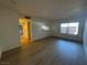 Spacious living room featuring wood-look floors and a view into the kitchen at 1474 Santa Anita Dr # B, Las Vegas, NV 89119