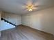 Living room showcases wood flooring and a staircase with access to closet and front door at 1474 Santa Anita Dr # B, Las Vegas, NV 89119