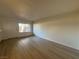 Living room with a large window allowing plenty of natural light and wood-look flooring at 1474 Santa Anita Dr # B, Las Vegas, NV 89119