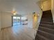 Spacious living room with wood floors, leads to a back sliding glass door and stairs at 1474 Santa Anita Dr # B, Las Vegas, NV 89119