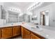 Bathroom featuring dual sinks, large mirrors, and modern lighting at 1575 W Warm Springs Rd # 121, Henderson, NV 89014