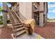 Apartment complex exterior with stairs, neutral color stucco and desert landscaping at 1575 W Warm Springs Rd # 121, Henderson, NV 89014