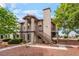Exterior view of charming two-story condo with red rock landscaping at 1575 W Warm Springs Rd # 121, Henderson, NV 89014
