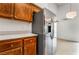 Kitchen featuring wood cabinets and stainless steel refrigerator at 1575 W Warm Springs Rd # 121, Henderson, NV 89014